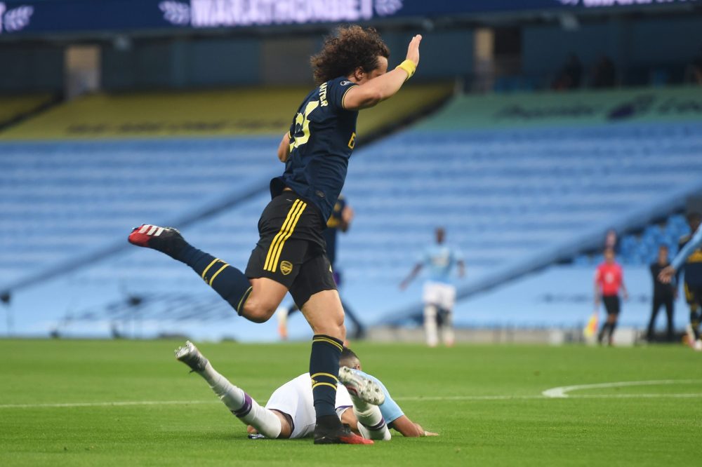 MANCHESTER, ENGLAND - JUNE 17: David Luiz of Arsenal battles for possession with with Riyad Mahrez of Manchester City which leads to a penalty for Manchester City and a red card for David Luiz during the Premier League match between Manchester City and Arsenal FC at Etihad Stadium on June 17, 2020 in Manchester, United Kingdom. (Photo by Peter Powell/Pool via Getty Images)