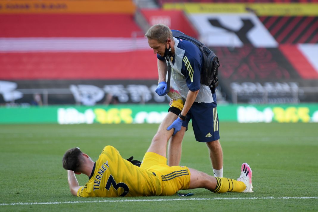 SOUTHAMPTON, ENGLAND - JUNE 25: Kieran Tierney of Arsenal receives medical treatment during the Premier League match between Southampton FC and Arsenal FC at St Mary's Stadium on June 25, 2020 in Southampton, United Kingdom. (Photo by Mike Hewitt/Getty Images)