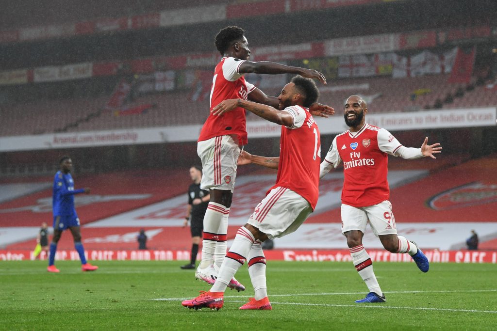LONDON, ENGLAND - JULY 07: Pierre-Emerick Aubameyang of Arsenal celebrates with teammates Bukayo Saka and Alexandre Lacazette after scoring his team's first goal during the Premier League match between Arsenal FC and Leicester City at Emirates Stadium on July 07, 2020 in London, England. Football Stadiums around Europe remain empty due to the Coronavirus Pandemic as Government social distancing laws prohibit fans inside venues resulting in all fixtures being played behind closed doors. (Photo by Shaun Botterill/Getty Images)