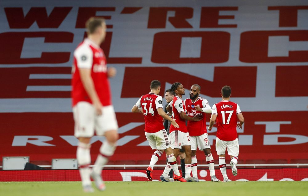 LONDON, ENGLAND - JULY 15: Reiss Nelson of Arsenal celebrates with teammates after scoring his sides second goal during the Premier League match between Arsenal FC and Liverpool FC at Emirates Stadium on July 15, 2020 in London, England. Football Stadiums around Europe remain empty due to the Coronavirus Pandemic as Government social distancing laws prohibit fans inside venues resulting in all fixtures being played behind closed doors. (Photo by Paul Childs/Pool via Getty Images)