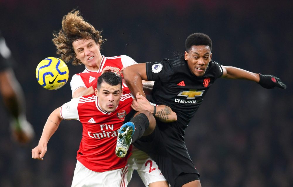 LONDON, ENGLAND - JANUARY 01: David Luiz and Granit Xhaka of Arsenal compete for the ball with Anthony Martial of Manchester United during the Premier League match between Arsenal FC and Manchester United at Emirates Stadium on January 01, 2020 in London, United Kingdom. (Photo by Clive Mason/Getty Images)