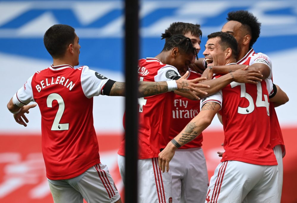 LONDON, ENGLAND - JULY 01: Granit Xhaka of Arsenal celebrates with teammates after scoring his team's second goal during the Premier League match between Arsenal FC and Norwich City at Emirates Stadium on July 01, 2020 in London, England. Football Stadiums around Europe remain empty due to the Coronavirus Pandemic as Government social distancing laws prohibit fans inside venues resulting in all fixtures being played behind closed doors. (Photo by Shaun Botterill/Getty Images)