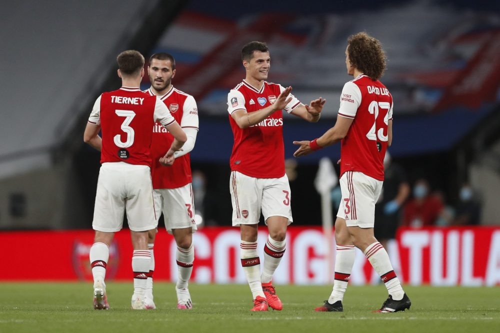 LONDON, ENGLAND - JULY 18: Granit Xhaka of Arsenal and David Luiz of Arsenal celebrate following the FA Cup Semi Final match between Arsenal and Manchester City at Wembley Stadium on July 18, 2020 in London, England. Football Stadiums around Europe remain empty due to the Coronavirus Pandemic as Government social distancing laws prohibit fans inside venues resulting in all fixtures being played behind closed doors. (Photo by Matthew Childs/Pool via Getty Images)