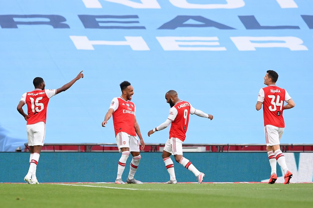LONDON, ENGLAND - JULY 18: Pierre-Emerick Aubameyang of Arsenal celebrates with teammates after scoring his team's first goal during the FA Cup Semi Final match between Arsenal and Manchester City at Wembley Stadium on July 18, 2020 in London, England. Football Stadiums around Europe remain empty due to the Coronavirus Pandemic as Government social distancing laws prohibit fans inside venues resulting in all fixtures being played behind closed doors. (Photo by Justin Tallis/Pool via Getty Images)