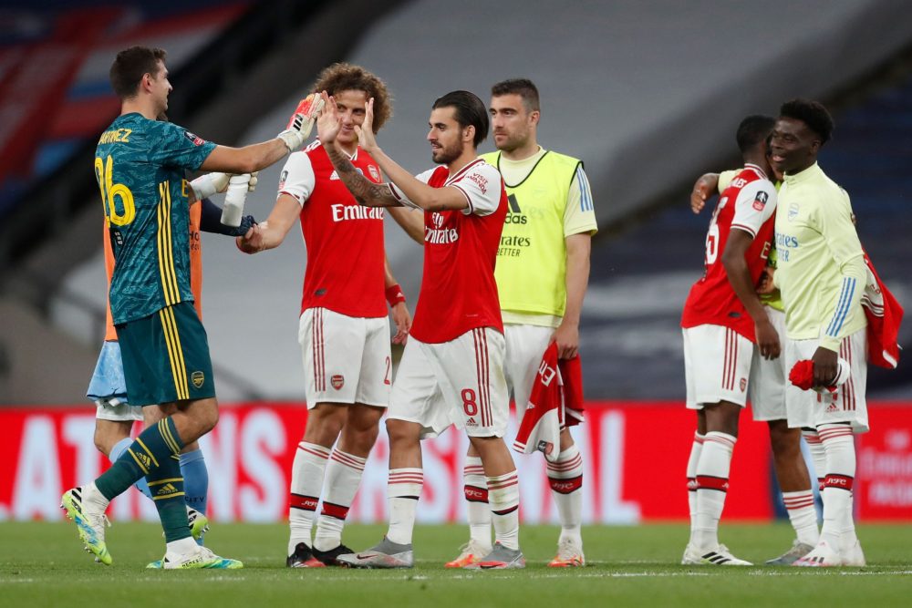 Arsenal's Argentinian goalkeeper Emiliano Martinez (L) celebrates with Arsenal's Brazilian defender David Luiz (2L) and Arsenal's Spanish midfielder Dani Ceballos (3L) at the end of the English FA Cup semi-final football match between Arsenal and Manchester City at Wembley Stadium in London, on July 18, 2020. (Photo by MATTHEW CHILDS / POOL / AFP)