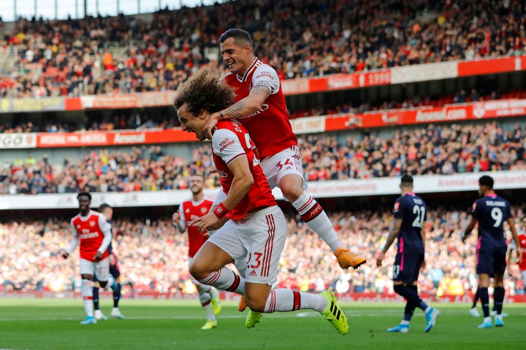 Asenal's Brazilian defender David Luiz (L) celebrates with Arsenal's Swiss midfielder Granit Xhaka after scoring the opening goal of the English Premier League football match between Arsenal and Bournemouth at the Emirates Stadium in London on October 6, 2019. (Photo by Tolga AKMEN / AFP)