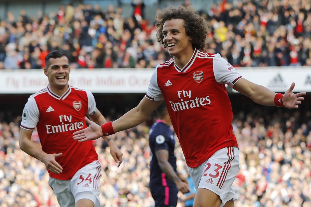 Arsenal's Brazilian defender David Luiz (R) celebrates with Arsenal's Swiss midfielder Granit Xhaka (L) after scoring the opening goal of the English Premier League football match between Arsenal and Bournemouth at the Emirates Stadium in London on October 6, 2019. (Photo by Tolga AKMEN / AFP)