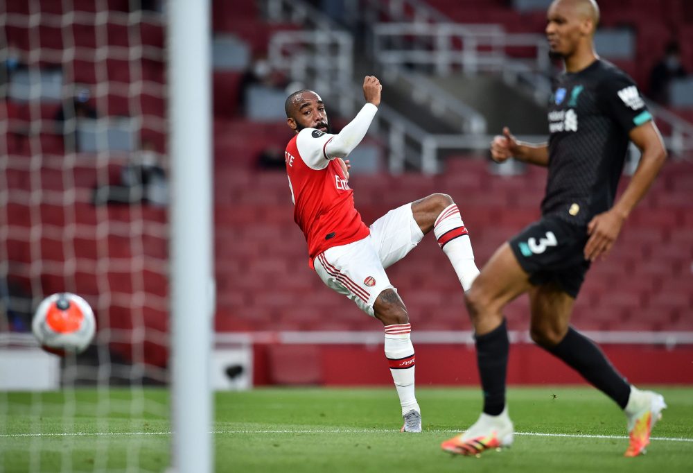 Arsenal's French striker Alexandre Lacazette hits a shot to score his team's first goal during the English Premier League football match between Arsenal and Liverpool at the Emirates Stadium in London on July 15, 2020. (Photo by Glyn KIRK / POOL / AFP)