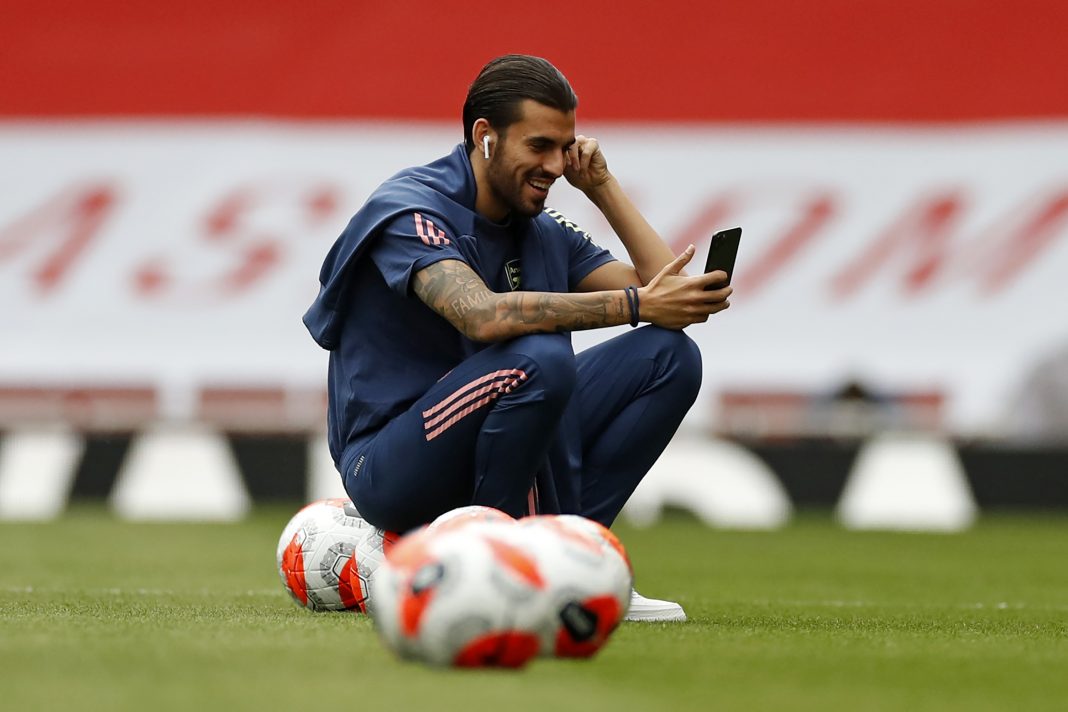 Arsenal's Spanish midfielder Dani Ceballos smiles as he checks his phone on the pitch ahead of the English Premier League football match between Arsenal and Liverpool at the Emirates Stadium in London on July 15, 2020. (Photo by PAUL CHILDS/POOL/AFP via Getty Images)