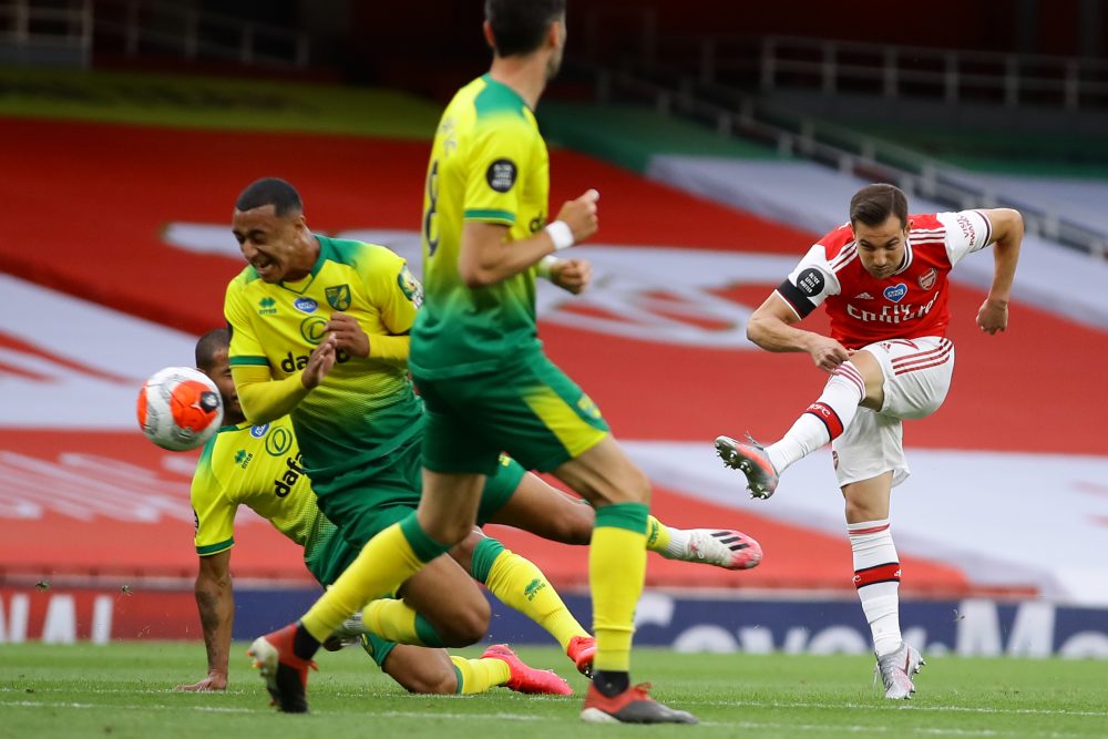 Arsenal's German-born Portuguese defender Cedric Soares (R) shoots and scores a goal during the English Premier League football match between Arsenal and Norwich City at the Emirates Stadium in London on July 1, 2020. (Photo by Richard Heathcote / POOL / AFP)