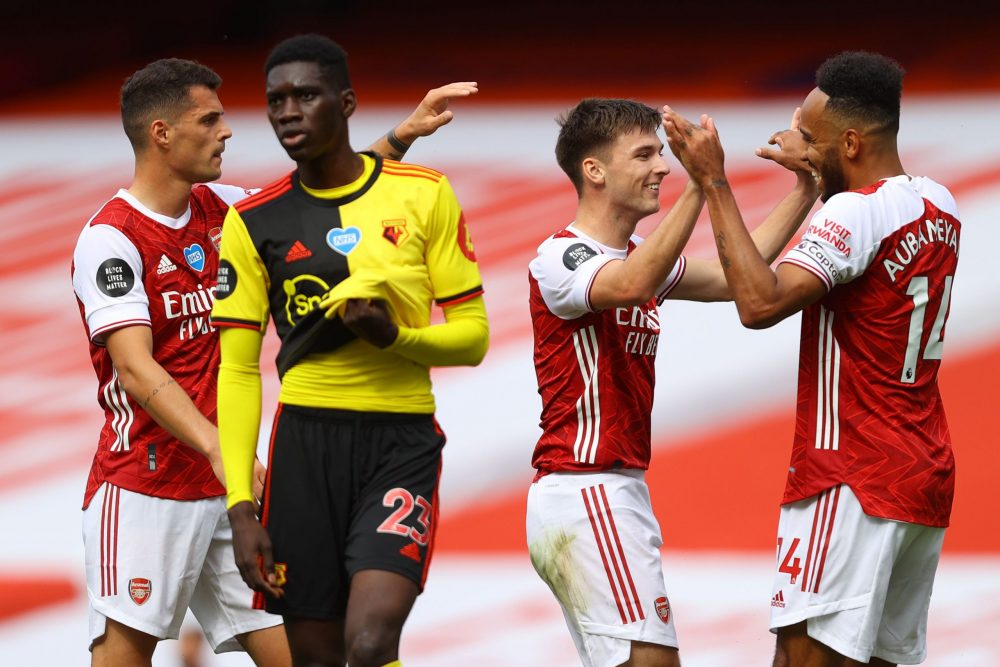 Arsenal's Scottish defender Kieran Tierney (2R) celebrates with Arsenal's Gabonese striker Pierre-Emerick Aubameyang after scoring their second goal during the English Premier League football match between Arsenal and Watford at the Emirates Stadium in London on July 26, 2020. (Photo by Julian Finney / POOL / AFP)