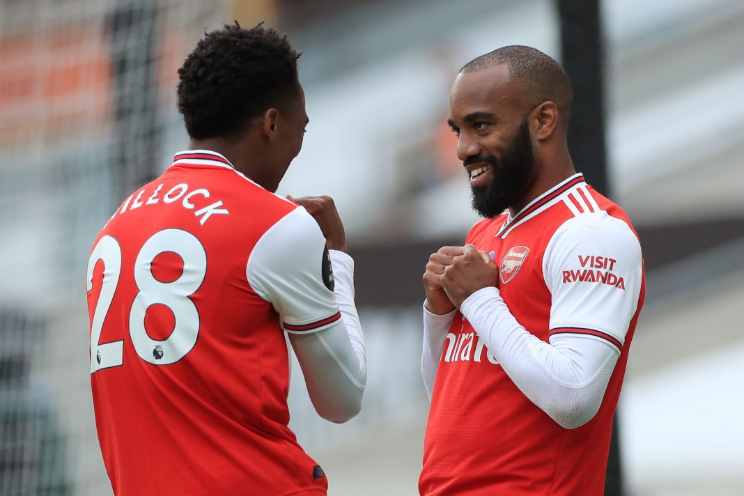 Arsenal's French striker Alexandre Lacazette (R) celebrates scoring their second goal with Arsenal's English midfielder Joe Willock (L) during the English Premier League football match between Wolverhampton Wanderers and Arsenal at the Molineux stadium in Wolverhampton, central England on July 4, 2020. (Photo by MIKE EGERTON / POOL / AFP) / RESTRICTED TO EDITORIAL USE. No use with unauthorized audio, video, data, fixture lists, club/league logos or 'live' services. Online in-match use limited to 120 images. An additional 40 images may be used in extra time. No video emulation. Social media in-match use limited to 120 images. An additional 40 images may be used in extra time. No use in betting publications, games or single club/league/player publications. / (Photo by MIKE EGERTON/POOL/AFP via Getty Images)