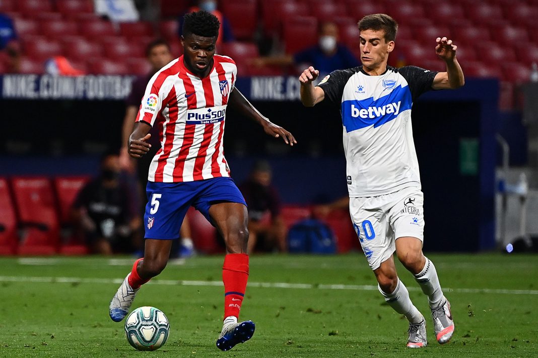 Alaves' Spanish midfielder Pere Pons (R) challenges Atletico Madrid's Ghanaian midfielder Thomas Partey during the Spanish League football match between Atletico Madrid and Alaves at the Wanda Metropolitan stadium in Madrid on June 27, 2020. (Photo by Gabriel BOUYS / AFP) (Photo by GABRIEL BOUYS/AFP via Getty Images)