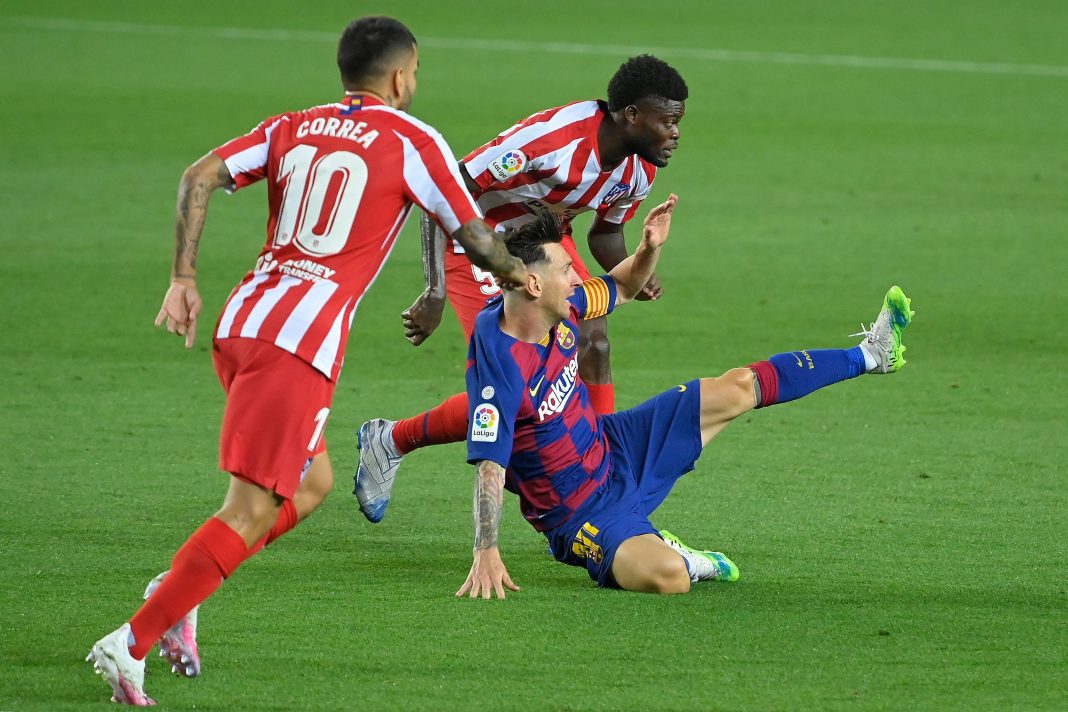 Barcelona's Argentine forward Lionel Messi (R) challenges Atletico Madrid's Ghanaian midfielder Thomas Partey and Atletico Madrid's Argentine forward Angel Correa (L) during the Spanish League football match between FC Barcelona and Club Atletico de Madrid at the Camp Nou stadium in Barcelona on June 30, 2020. (Photo by Lluis GENE / AFP) (Photo by LLUIS GENE/AFP via Getty Images)