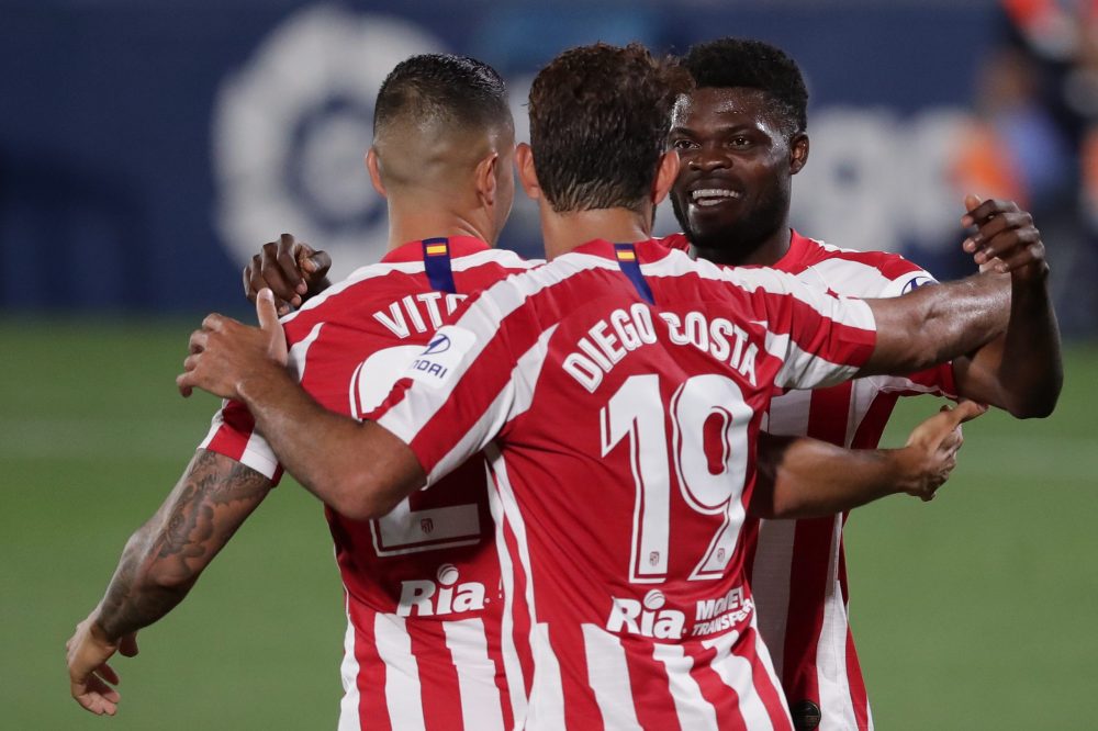 GETAFE, SPAIN - JULY 16: Thomas Teye Partey (R) of Atletico de Madrid celebrates scoring their second goal with teammate Diego Costa (2ndL) and Victor Machin alias Vitolo (L) during the Liga match between Getafe CF and Club Atletico de Madrid at Coliseum Alfonso Perez on July 16, 2020 in Getafe, Spain. (Photo by Gonzalo Arroyo Moreno/Getty Images)