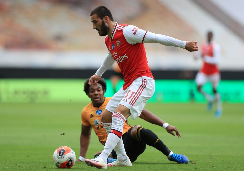 WOLVERHAMPTON, ENGLAND - JULY 04: Sead Kolasinac of Arsenal and Adama Traore of Wolverhampton Wanderers battle for the ball during the Premier League match between Wolverhampton Wanderers and Arsenal FC at Molineux on July 04, 2020 in Wolverhampton, England. Football Stadiums around Europe remain empty due to the Coronavirus Pandemic as Government social distancing laws prohibit fans inside venues resulting in all fixtures being played behind closed doors. (Photo by Mike Egerton/Pool via Getty Images)