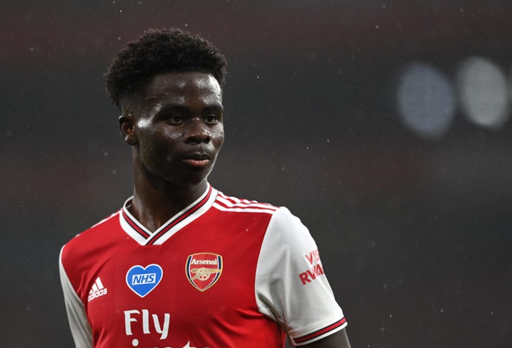 LONDON, ENGLAND - JULY 07: Bukayo Saka of Arsenal looks on during the Premier League match between Arsenal FC and Leicester City at Emirates Stadium on July 07, 2020 in London, England. Football Stadiums around Europe remain empty due to the Coronavirus Pandemic as Government social distancing laws prohibit fans inside venues resulting in all fixtures being played behind closed doors. (Photo by Shaun Botterill/Getty Images)