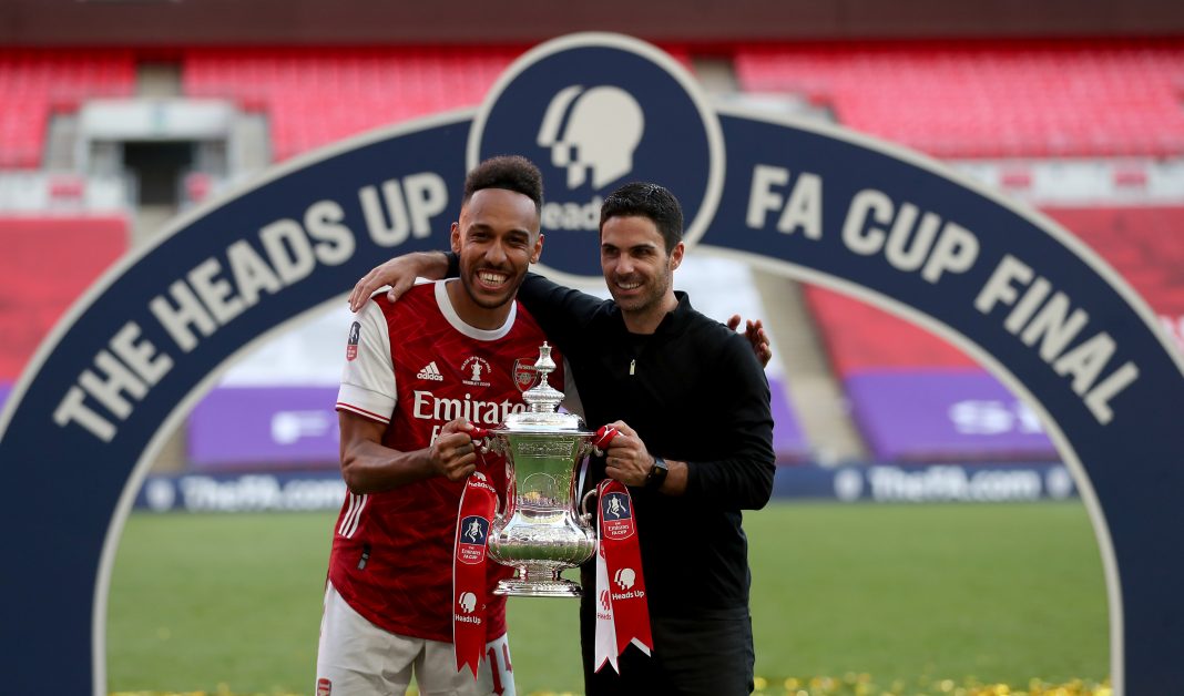 Pierre-Emerick Aubameyang finally signs new Arsenal deal LONDON, ENGLAND - AUGUST 01: Pierre-Emerick Aubameyang of Arsenal poses with Mikel Arteta, Manager of Arsenal and the FA Cup Trophy after their teams victory in the Heads Up FA Cup Final match between Arsenal and Chelsea at Wembley Stadium on August 01, 2020 in London, England. Football Stadiums around Europe remain empty due to the Coronavirus Pandemic as Government social distancing laws prohibit fans inside venues resulting in all fixtures being played behind closed doors. (Photo by Catherine Ivill/Getty Images)