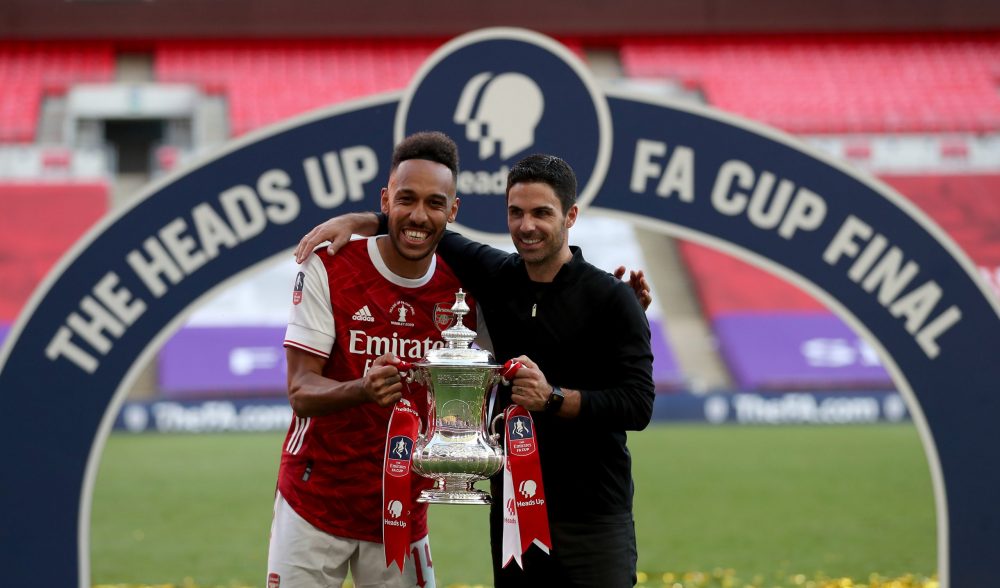 LONDON, ENGLAND - AUGUST 01: Pierre-Emerick Aubameyang of Arsenal poses with Mikel Arteta, Manager of Arsenal and the FA Cup Trophy after their teams victory in the Heads Up FA Cup Final match between Arsenal and Chelsea at Wembley Stadium on August 01, 2020 in London, England. Football Stadiums around Europe remain empty due to the Coronavirus Pandemic as Government social distancing laws prohibit fans inside venues resulting in all fixtures being played behind closed doors. (Photo by Catherine Ivill/Getty Images)
