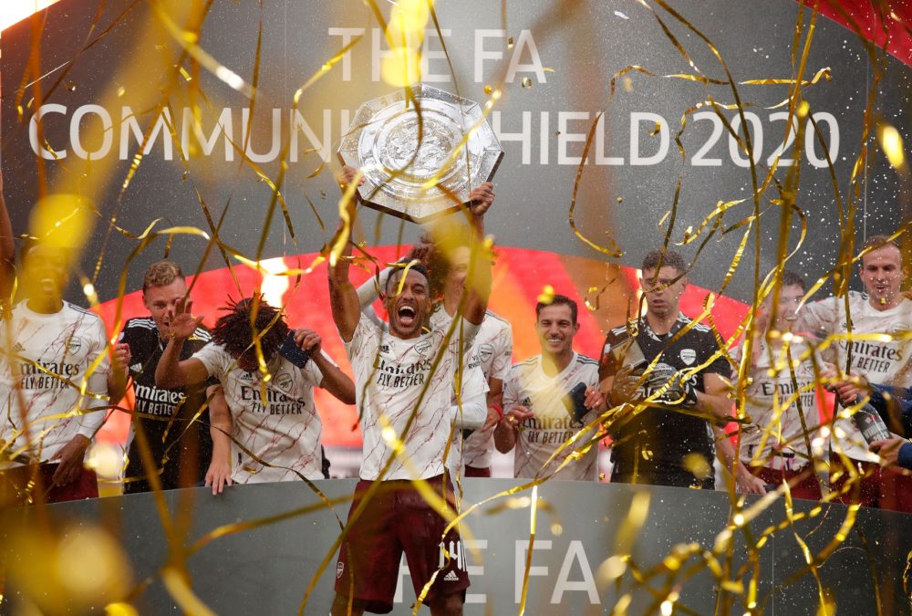 Arsenal's Gabonese striker Pierre-Emerick Aubameyang lifts the trophy after winning the English FA Community Shield football match between Arsenal and Liverpool at Wembley Stadium in north London on August 29, 2020. - Arsenal won the match 5-4 in a penalty shootout after drawing 1-1 in normal time. (Photo by ANDREW COULDRIDGE / POOL / AFP)