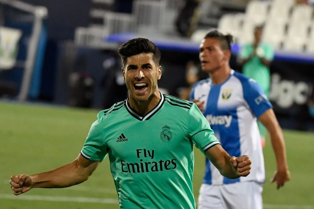Real Madrid's Spanish midfielder Marco Asensio celebrates after scoring during the Spanish league football match Club Deportivo Leganes SAD against Real Madrid CF at the Estadio Municipal Butarque in Leganes on July 19, 2020. (Photo by PIERRE-PHILIPPE MARCOU / AFP)