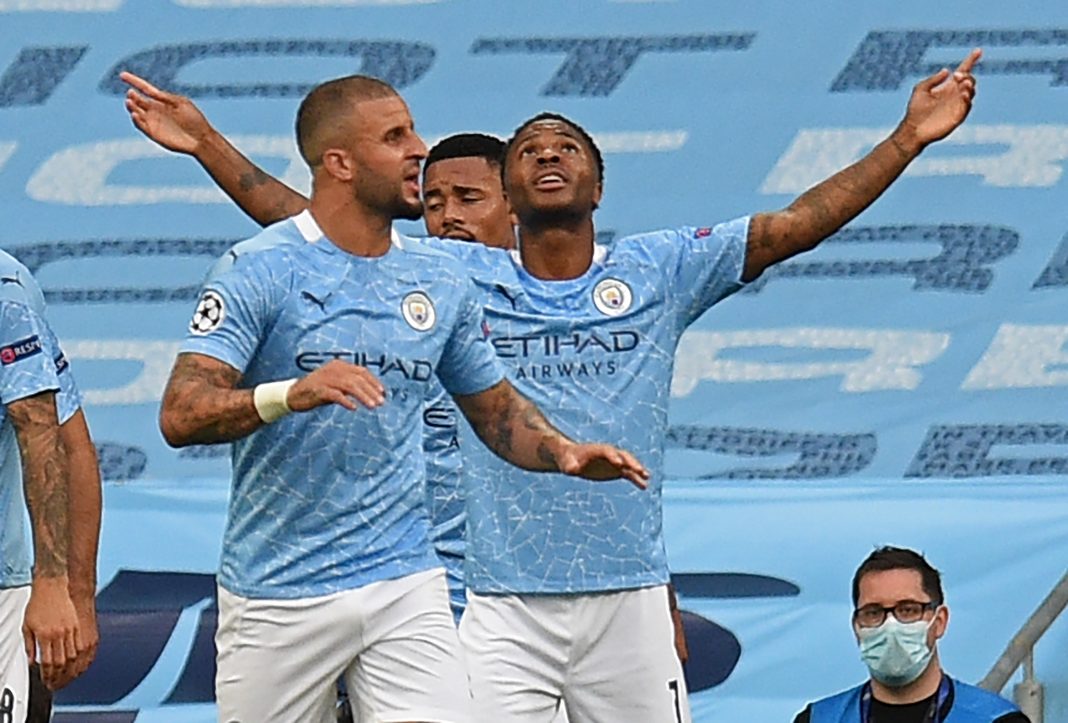 Manchester City's English midfielder Raheem Sterling (R) celebrates scoring the opening goal during the UEFA Champions League round of 16 second leg football match between Manchester City and Real Madrid at the Etihad Stadium in Manchester, north west England on August 7, 2020. (Photo by Oli SCARFF / POOL / AFP)