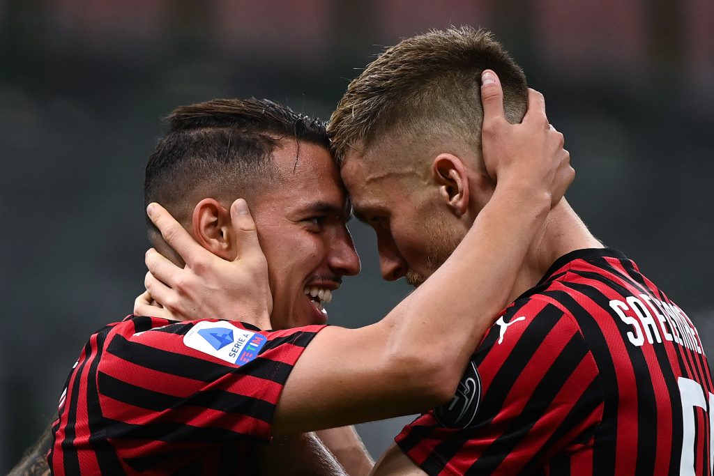 AC Milan's Algerian midfielder Ismael Bennacer (L) celebrates with AC Milan's Belgian midfielder Alexis Saelemaeker after scoring a goal during the Italian Serie A football match AC Milan vs Bologna played behind closed doors on July 15, 2020 at the San Siro Stadium in Milan, as the country eases its lockdown aimed at curbing the spread of the COVID-19 infection, caused by the novel coronavirus. (Photo by MARCO BERTORELLO / AFP)