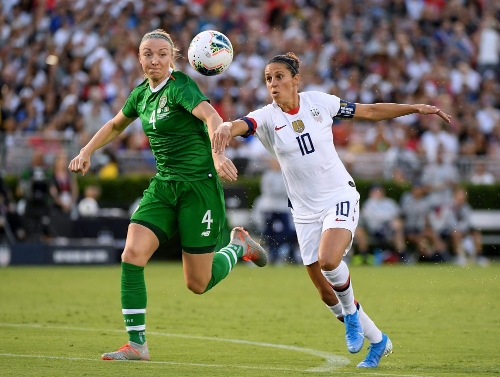 PASADENA, CALIFORNIA - AUGUST 03: Carli Lloyd #10 of the United States chases after a ball with Louise Quinn #4 of The Republic of Ireland during the first half of the first game of the USWNT Victory Tour at Rose Bowl on August 03, 2019 in Pasadena, California. (Photo by Harry How/Getty Images)