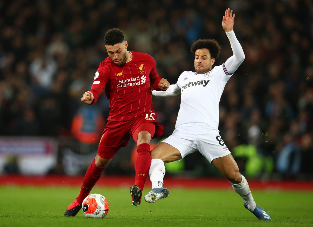LIVERPOOL, ENGLAND - FEBRUARY 24: Alex Oxlade-Chamberlain of Liverpool is tackled by Felipe Anderson of West Ham United during the Premier League match between Liverpool FC and West Ham United at Anfield on February 24, 2020 in Liverpool, United Kingdom. (Photo by Clive Brunskill/Getty Images)
