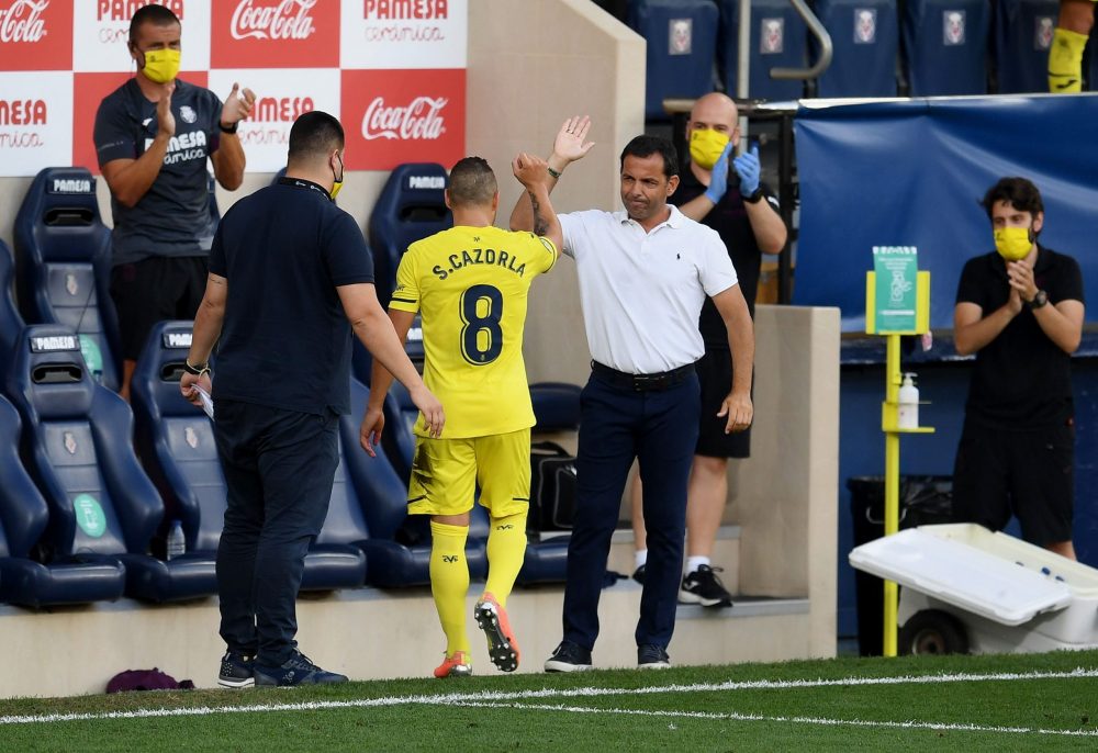VILLAREAL, SPAIN - JULY 19: Santi Cazorla of Villarreal leaves the pitch and shakes hand with Javier Calleja, Manager of Villarreal after his last match for Villareall during the Liga match between Villarreal CF and SD Eibar SAD at Estadio de la Ceramica on July 19, 2020 in Villareal, Spain. Football Stadiums around Europe remain empty due to the Coronavirus Pandemic as Government social distancing laws prohibit fans inside venues resulting in all fixtures being played behind closed doors. (Photo by David Ramos/Getty Images)