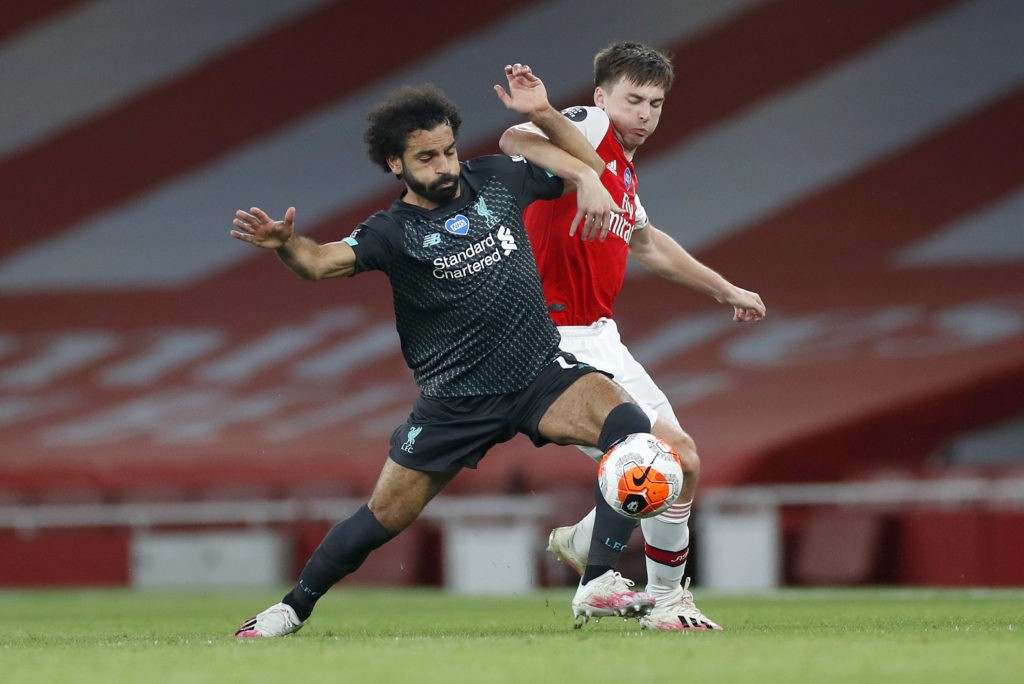 LONDON, ENGLAND - JULY 15: Mohamed Salah of Liverpool is challenged by Kieran Tierney of Arsenal during the Premier League match between Arsenal FC and Liverpool FC at Emirates Stadium on July 15, 2020 in London, England. Football Stadiums around Europe remain empty due to the Coronavirus Pandemic as Government social distancing laws prohibit fans inside venues resulting in all fixtures being played behind closed doors. (Photo by Paul Childs/Pool via Getty Images)