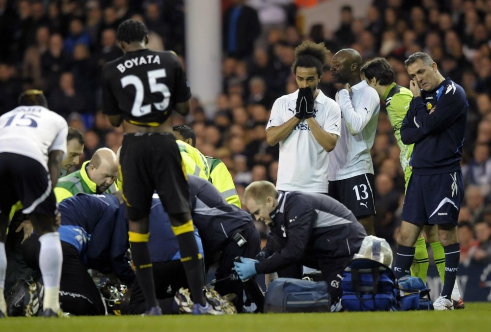 Bolton Wanderer's manager Owen Coyle (R) stands beside Tottenham and Bolton players as English midfielder Fabrice Muamba is treated by medical staff after collapsing during the English FA Cup quarter-final football match between Tottenham Hotspur and Bolton Wanderers at White Hart Lane in north London, England on March 17, 2012. The game was abandoned at half-time as Muamba was taken to hospital. AFP PHOTO/OLLY GREENWOOD