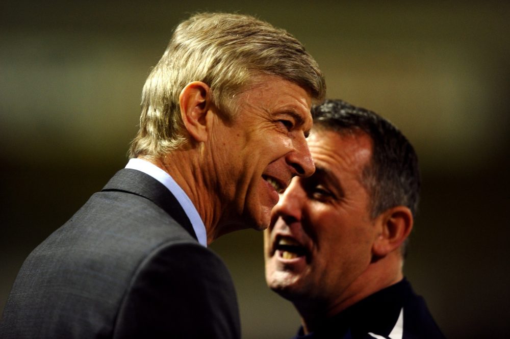 BOLTON, ENGLAND - FEBRUARY 01: Bolton Wanderers Manager Owen Coyle (R) speaks to Arsenal Manager Arsene Wenger prior to the Barclays Premier League match between Bolton Wanderers and Arsenal at the Reebok Stadium on February 1, 2012 in Bolton, England. (Photo by Laurence Griffiths/Getty Images)
