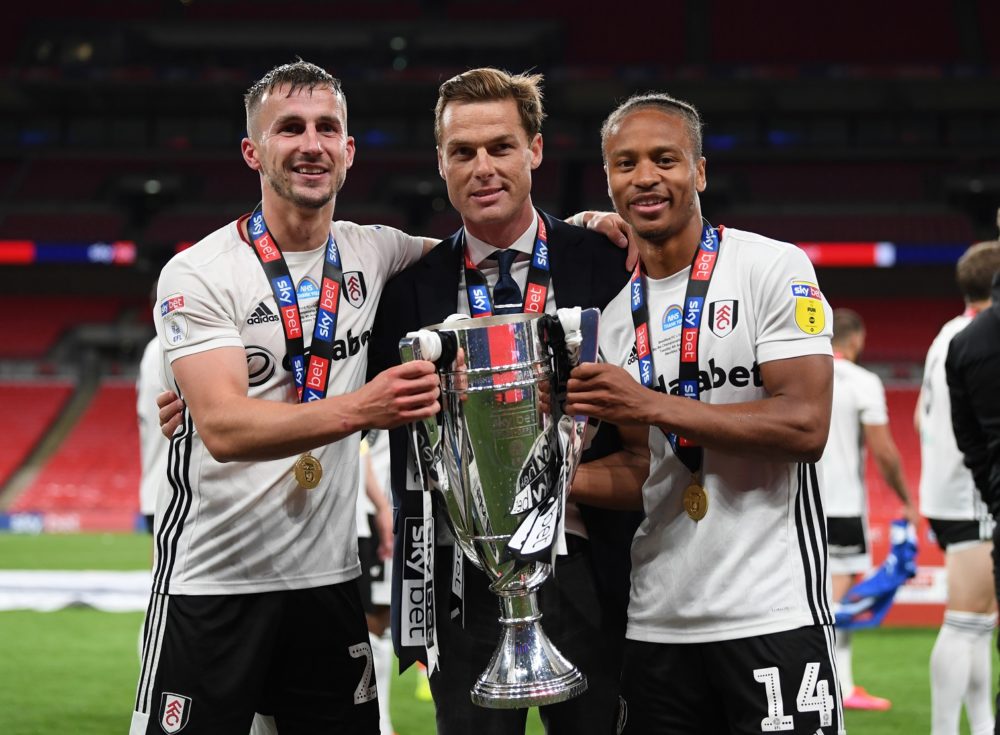 LONDON, ENGLAND - AUGUST 04: Scott Parker manager of Fulham, Joe Bryan and Bobby Decordova-Reid of Fulham celebrate with the trophy after the Sky Bet Championship Play Off Final match between Brentford and Fulham at Wembley Stadium on August 04, 2020 in London, England. Football Stadiums around Europe remain empty due to the Coronavirus Pandemic as Government social distancing laws prohibit fans inside venues resulting in all fixtures being played behind closed doors. (Photo by Shaun Botterill/Getty Images)