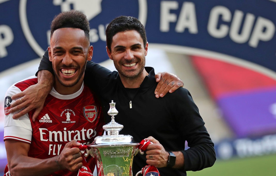 Arsenal's Gabonese striker Pierre-Emerick Aubameyang (L) and Arsenal's Spanish head coach Mikel Arteta hold the winner's trophy as the team celebrates victory after the English FA Cup final football match between Arsenal and Chelsea at Wembley Stadium in London, on August 1, 2020. - Arsenal won the match 2-1. (Photo by Catherine Ivill / POOL / AFP) / NOT FOR MARKETING OR ADVERTISING USE / RESTRICTED TO EDITORIAL USE (Photo by CATHERINE IVILL/POOL/AFP via Getty Images)