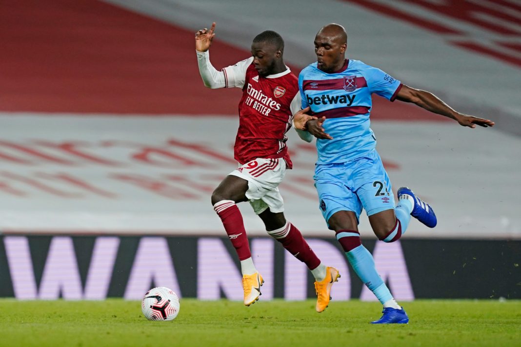 Arsenal's French-born Ivorian midfielder Nicolas Pepe (L) tries to hold off West Ham United's Italian defender Angelo Ogbonna (R) during the English Premier League football match between Arsenal and West Ham United at the Emirates Stadium in London on September 19, 2020. (Photo by WILL OLIVER/POOL/AFP via Getty Images)