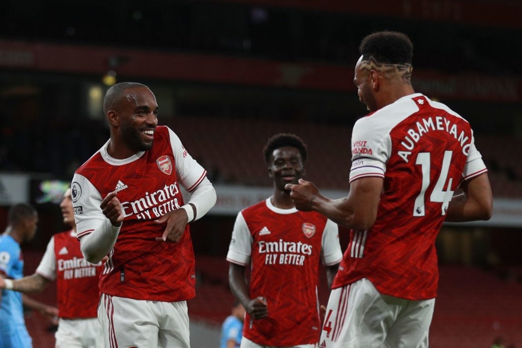Arsenal's French striker Alexandre Lacazette (L) celebrates scoring the opening goal with Arsenal's Gabonese striker Pierre-Emerick Aubameyang who provided the assist during the English Premier League football match between Arsenal and West Ham United at the Emirates Stadium in London on September 19, 2020. (Photo by Ian Walton / POOL / AFP)