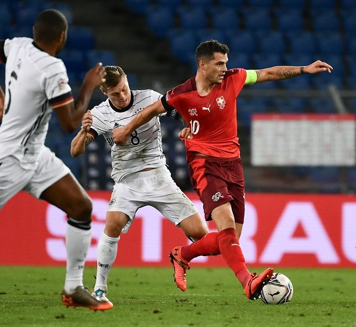 Switzerland's midfielder Granit Xhaka (R) fights for the ball with Germany's midfielder Toni Kroos (2nd-R) during the UEFA Nations League, league A, day 2, group 4 football match between Switzerland and Germany at the St. Jakob-Park in Basel, on September 6, 2020. (Photo by Fabrice COFFRINI / AFP) (Photo by FABRICE COFFRINI/AFP via Getty Images)
