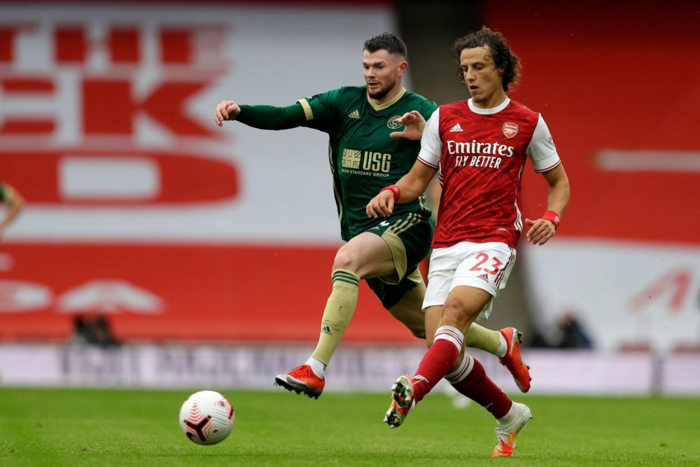 Arsenal's Brazilian defender David Luiz (R) vies for the ball against Sheffield United's Scottish striker Oliver Burke (L) during the English Premier League football match between Arsenal and Sheffield United at the Emirates Stadium in London on October 4, 2020. (Photo by Kirsty Wigglesworth / POOL / AFP)