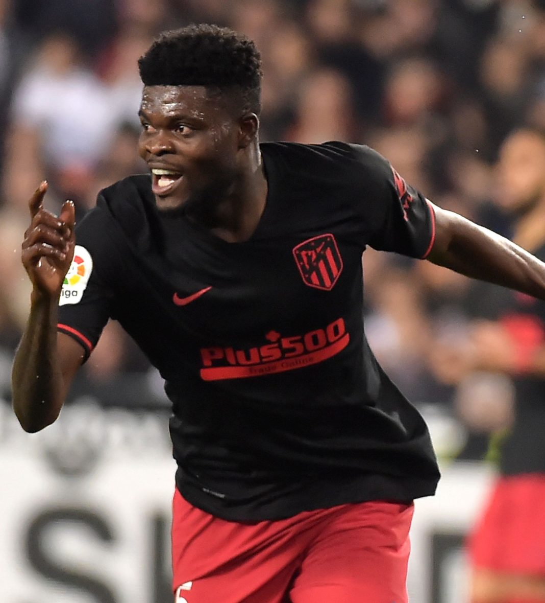Atletico Madrid's Ghanaian midfielder Thomas Partey (C) celebrates after scoring during the Spanish league football match between Valencia CF and Club Atletico de Madrid at the Mestalla stadium in Valencia on February 14, 2020. (Photo by JOSE JORDAN / AFP) (Photo by JOSE JORDAN/AFP via Getty Images)