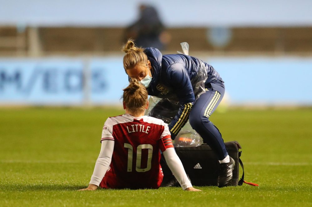 MANCHESTER, ENGLAND - OCTOBER 01: Kim Little of Arsenal FC is seen to by medical staff after sustaining an injury during the Vitality Women's FA Cup Semi Final match between Manchester City and Arsenal on October 01, 2020 in Manchester, England. Sporting stadiums around the UK remain under strict restrictions due to the Coronavirus Pandemic as Government social distancing laws prohibit fans inside venues resulting in games being played behind closed doors. (Photo by Catherine Ivill/Getty Images)
