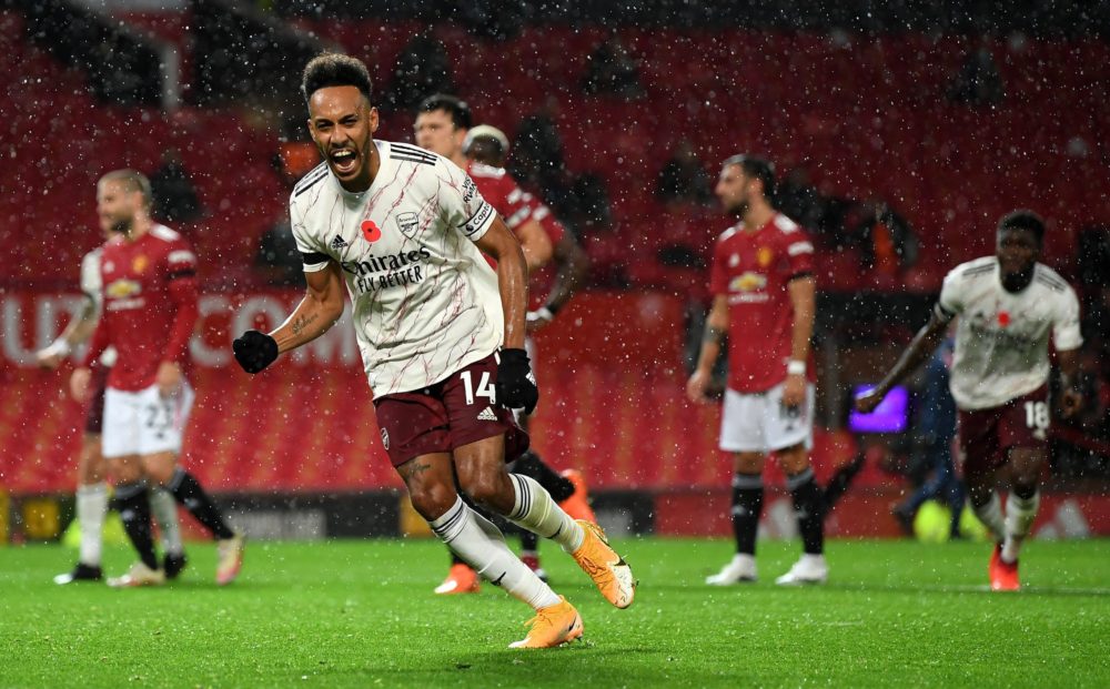 MANCHESTER, ENGLAND - NOVEMBER 01: Pierre-Emerick Aubameyang celebrates after scoring from the penalty spot during the Premier League match between Manchester United and Arsenal at Old Trafford on November 01, 2020 in Manchester, England. Sporting stadiums around the UK remain under strict restrictions due to the Coronavirus Pandemic as Government social distancing laws prohibit fans inside venues resulting in games being played behind closed doors. (Photo by Shaun Botterill/Getty Images)