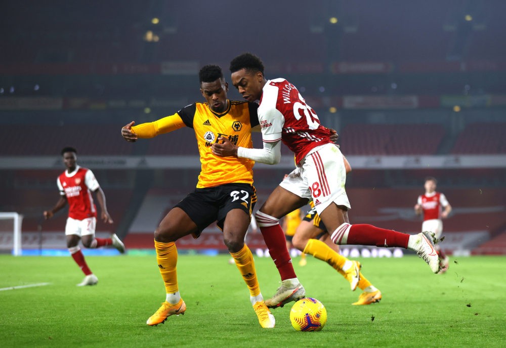 LONDON, ENGLAND - NOVEMBER 29: Nelson Semedo of Wolverhampton Wanderers battles for possession with Joe Willock of Arsenal during the Premier League match between Arsenal and Wolverhampton Wanderers at Emirates Stadium on November 29, 2020 in London, England. Sporting stadiums around the UK remain under strict restrictions due to the Coronavirus Pandemic as Government social distancing laws prohibit fans inside venues resulting in games being played behind closed doors. (Photo by Julian Finney/Getty Images)