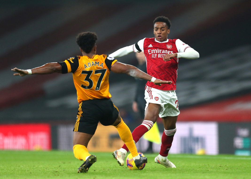 LONDON, ENGLAND - NOVEMBER 29: Joe Willock of Arsenal battles for possession with Adama Traore of Wolverhampton Wanderers during the Premier League match between Arsenal and Wolverhampton Wanderers at Emirates Stadium on November 29, 2020 in London, England. Sporting stadiums around the UK remain under strict restrictions due to the Coronavirus Pandemic as Government social distancing laws prohibit fans inside venues resulting in games being played behind closed doors. (Photo by Catherine Ivill/Getty Images)