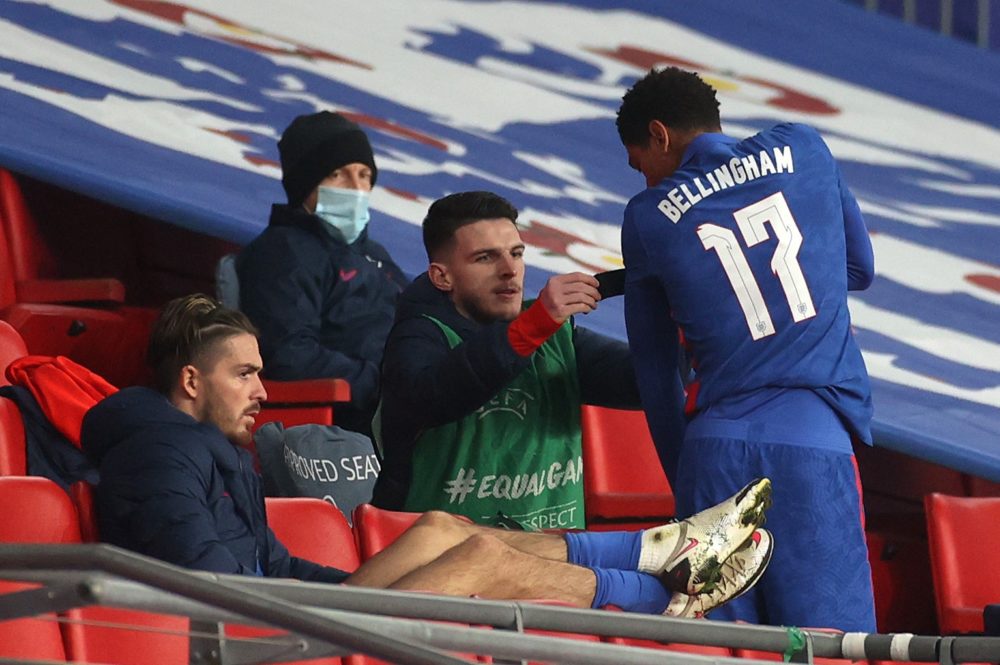 LONDON, ENGLAND - NOVEMBER 12: Declan Rice helps Jude Bellingham of England put on an armband during the international friendly match between England and the Republic of Ireland at Wembley Stadium on November 12, 2020 in London, England. Sporting stadiums around the UK remain under strict restrictions due to the Coronavirus Pandemic as Government social distancing laws prohibit fans inside venues resulting in games being played behind closed doors. (Photo by Carl Recine -