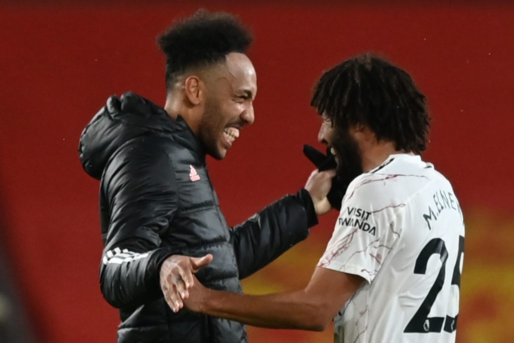 Arsenal's Gabonese striker Pierre-Emerick Aubameyang (L) celebrates with Arsenal's Egyptian midfielder Mohamed Elneny (R) at the end of the English Premier League football match between Manchester United and Arsenal at Old Trafford in Manchester, north west England, on November 1, 2020. (Photo by Shaun Botterill / POOL / AFP)