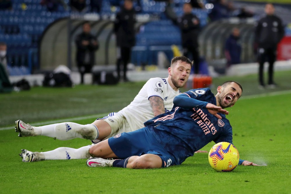 LEEDS, ENGLAND - NOVEMBER 22: Dani Ceballos of Arsenal is tackled by Liam Cooper of Leeds United during the Premier League match between Leeds United and Arsenal at Elland Road on November 22, 2020 in Leeds, England. Sporting stadiums around the UK remain under strict restrictions due to the Coronavirus Pandemic as Government social distancing laws prohibit fans inside venues resulting in games being played behind closed doors. (Photo by Molly Darlington - Pool/Getty Images)