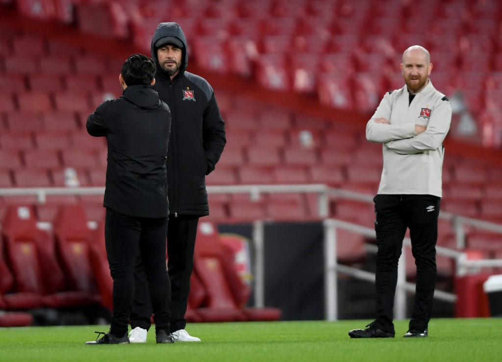 LONDON, ENGLAND: Filippo Giovagnoli, Head Coach of Dundalk (L) and Shane Keegan, Opposition Analyst of Dundalk (R) look on during the warm up prior to the UEFA Europa League Group B stage match between Arsenal FC and Dundalk FC at Emirates Stadium on October 29, 2020. (Photo by Mike Hewitt/Getty Images)