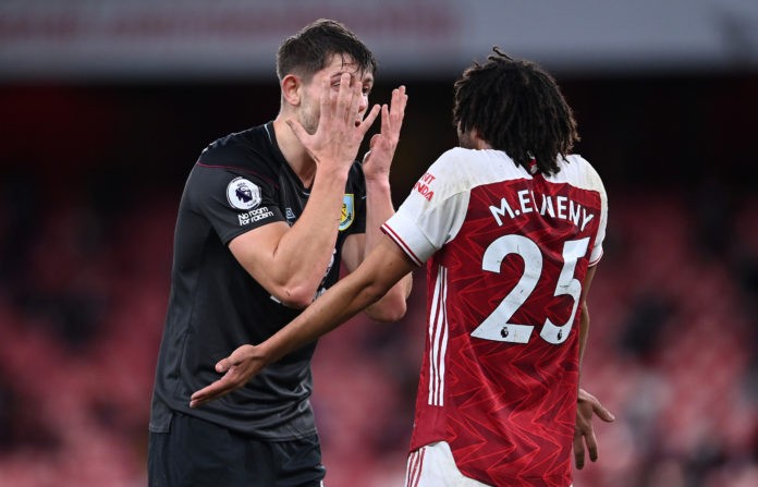LONDON, ENGLAND - DECEMBER 13: James Tarkowski of Burnley argues with Mohamed Elneny of Arsenal during the Premier League match between Arsenal and Burnley at Emirates Stadium on December 13, 2020 in London, England. A limited number of spectators (2000) are welcomed back to stadiums to watch elite football across England. This was following easing of restrictions on spectators in tiers one and two areas only. (Photo by Laurence Griffiths/Getty Images)