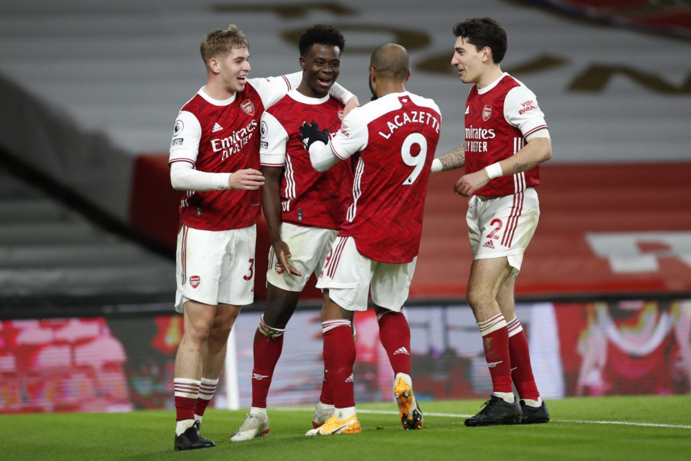 LONDON, ENGLAND - DECEMBER 26: Bukayo Saka of Arsenal celebrates with teammates Emile Smith Rowe, Alexandre Lacazette, and Hector Bellerin after scoring his team's third goal during the Premier League match between Arsenal and Chelsea at Emirates Stadium on December 26, 2020 in London, England. The match will be played without fans, behind closed doors as a Covid-19 precaution. (Photo by Andrew Boyers - Pool/Getty Images)